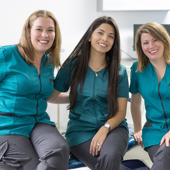 Dental team members smiling together