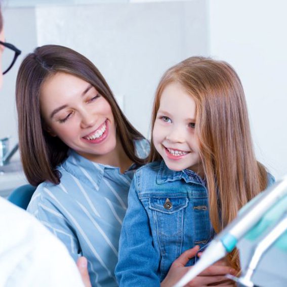 Parent and child talking with dentist