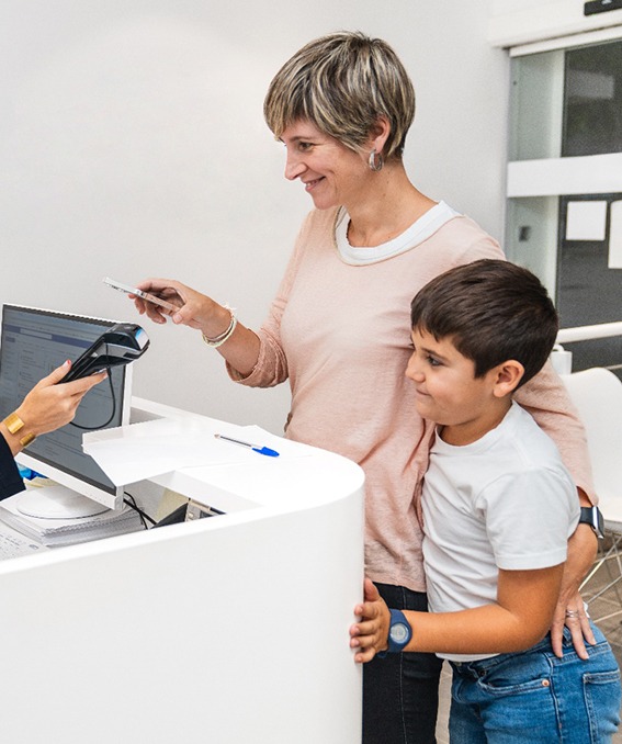 Happy Marietta parent and child paying dental team