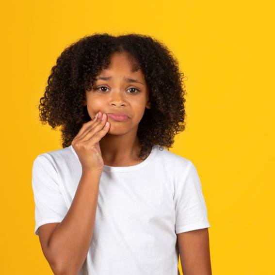 Preteen girl dealing with a toothache