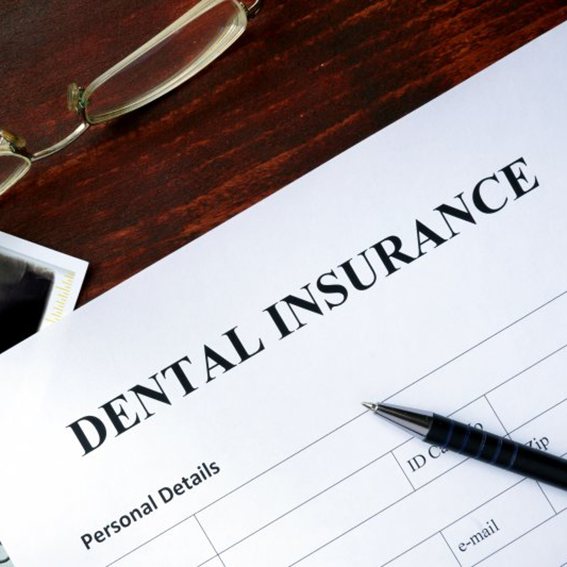 A form titled dental insurance sitting on a desk 