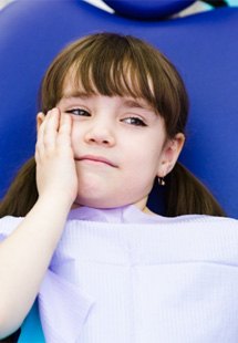 Girl with a toothache in the dental chair