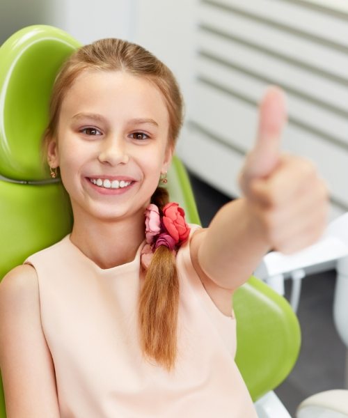 little girl giving a smile and thumbs up after receiving dental care in Marietta