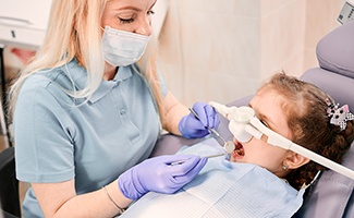 Little girl with nitrous oxide mask having dental exam
