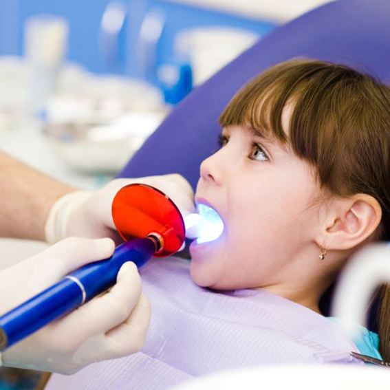 Dental curing light being used in child's mouth