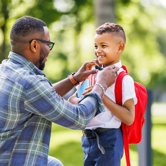 Dad prepares son for school