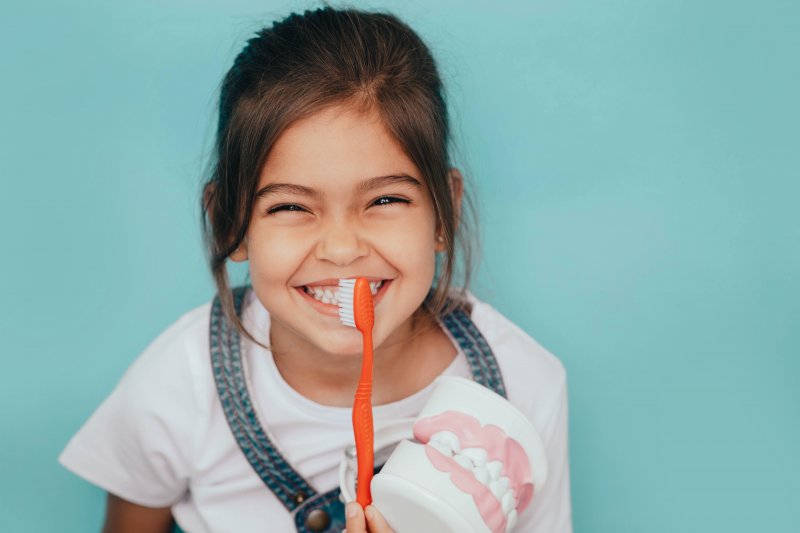 A child playing with a dental toy kit