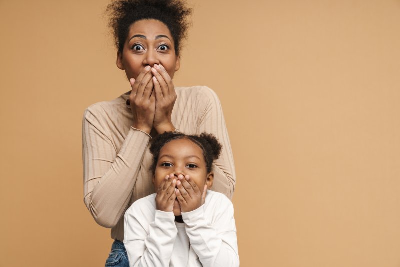 Parent and child learning about baby teeth fillings