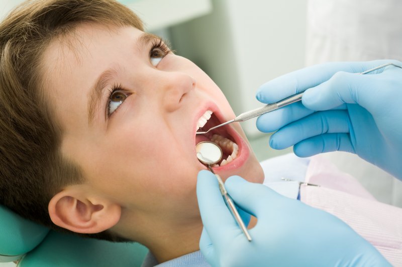 young boy having mouth checked
