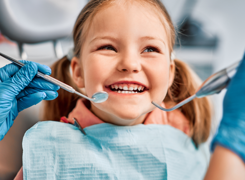 Child smiling in dental chair