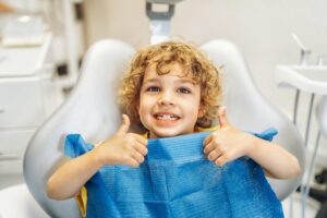 Child smiling during his dental checkup